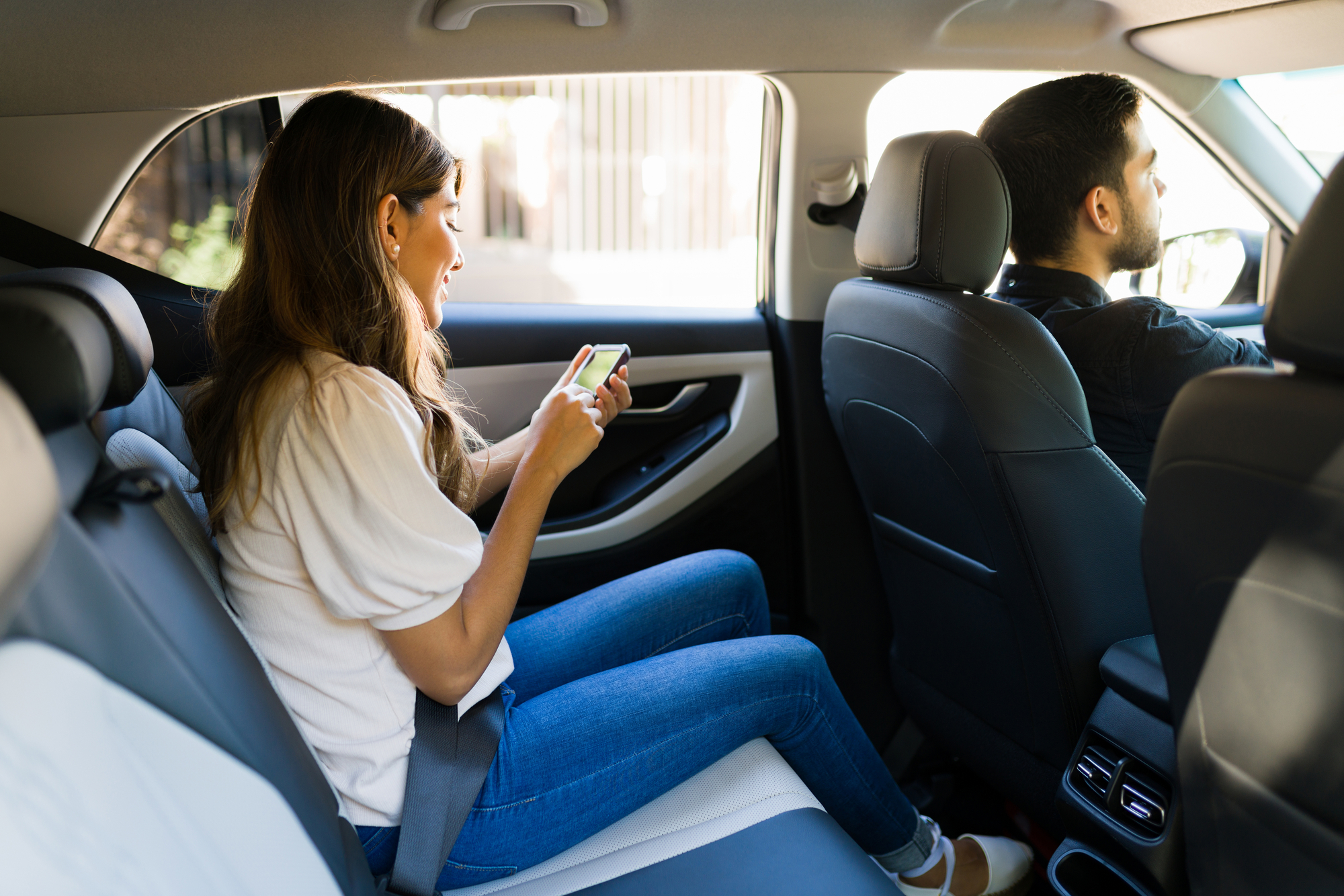 Why You Should Hire A Lyft Accident Lawyer - Female passenger texting in the car